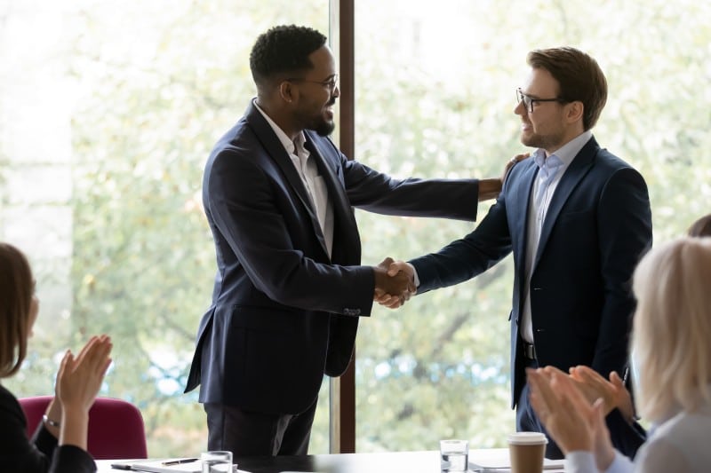 Confident businessmen shake hands greeting for excellent performance on the job